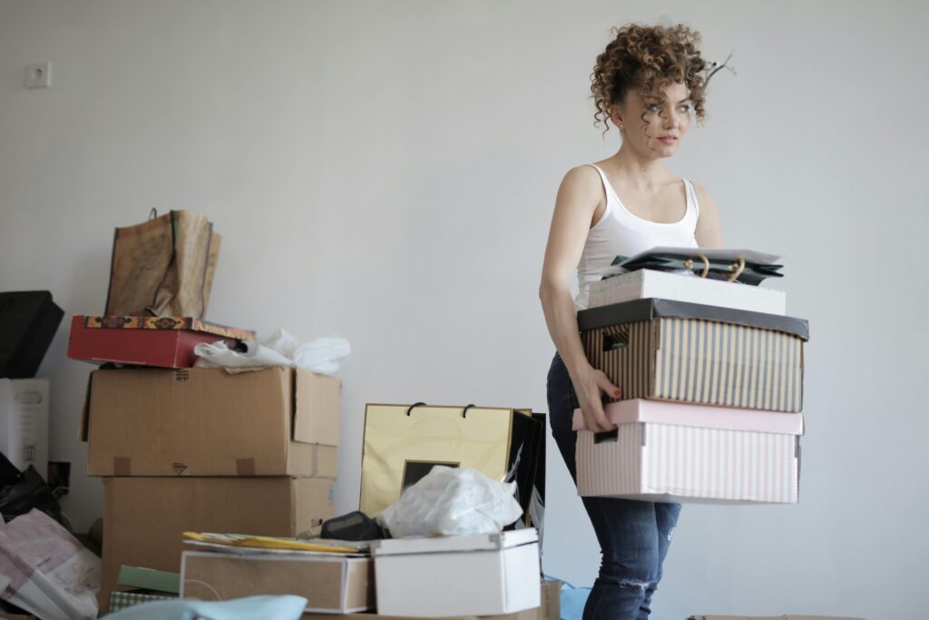 Woman moving boxes before professional move-out cleaning in virginia